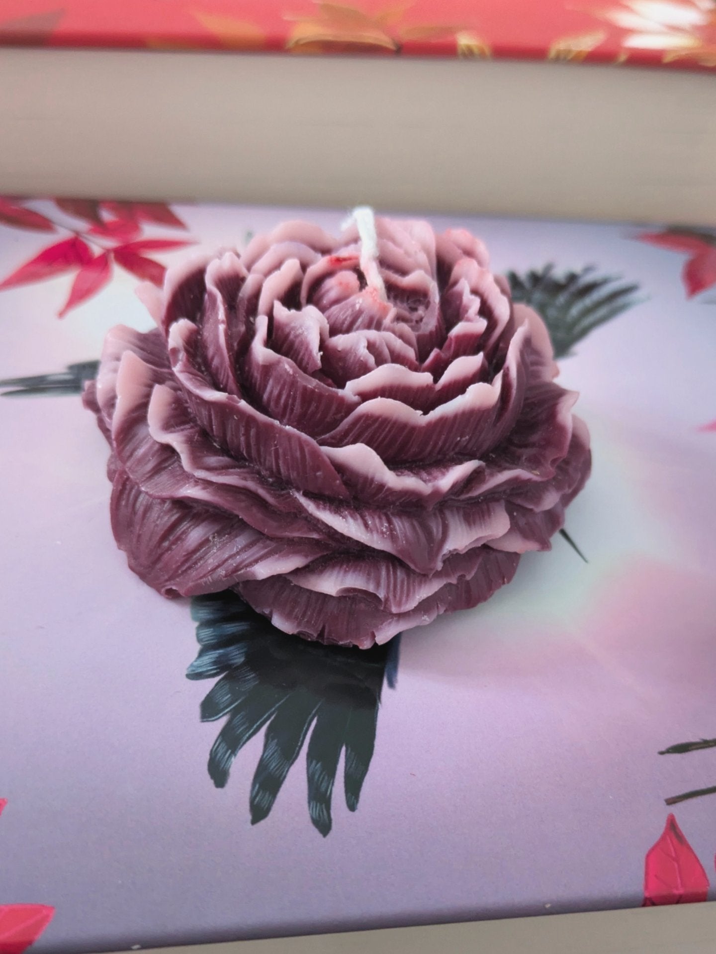 Purple Peony Rose candle by VitaUnlimited with a floral design, showcasing a decorative purple candle with peony and rose motifs.