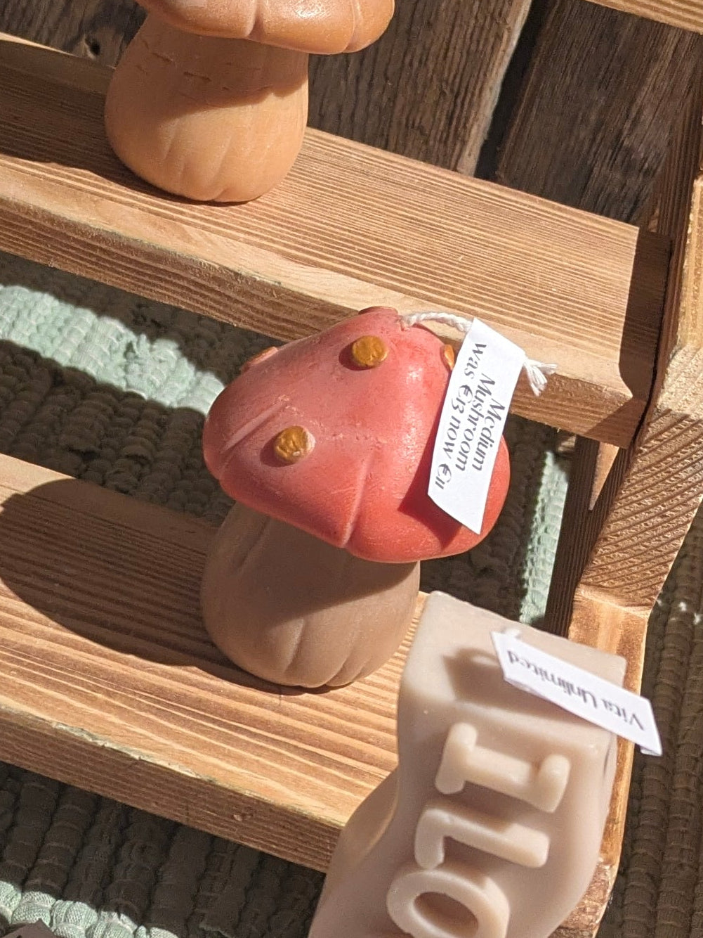 Medium mushroom candles by VitaUnlimited, showing beige mushroom-shaped candles on a rustic wooden surface.